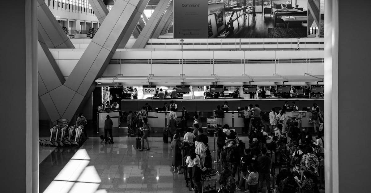 Black and white image of travelers at a bustling airport in Pasay, capturing the essence of global travel.